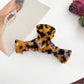 Beau claw clip placed on wooden surface with natural light