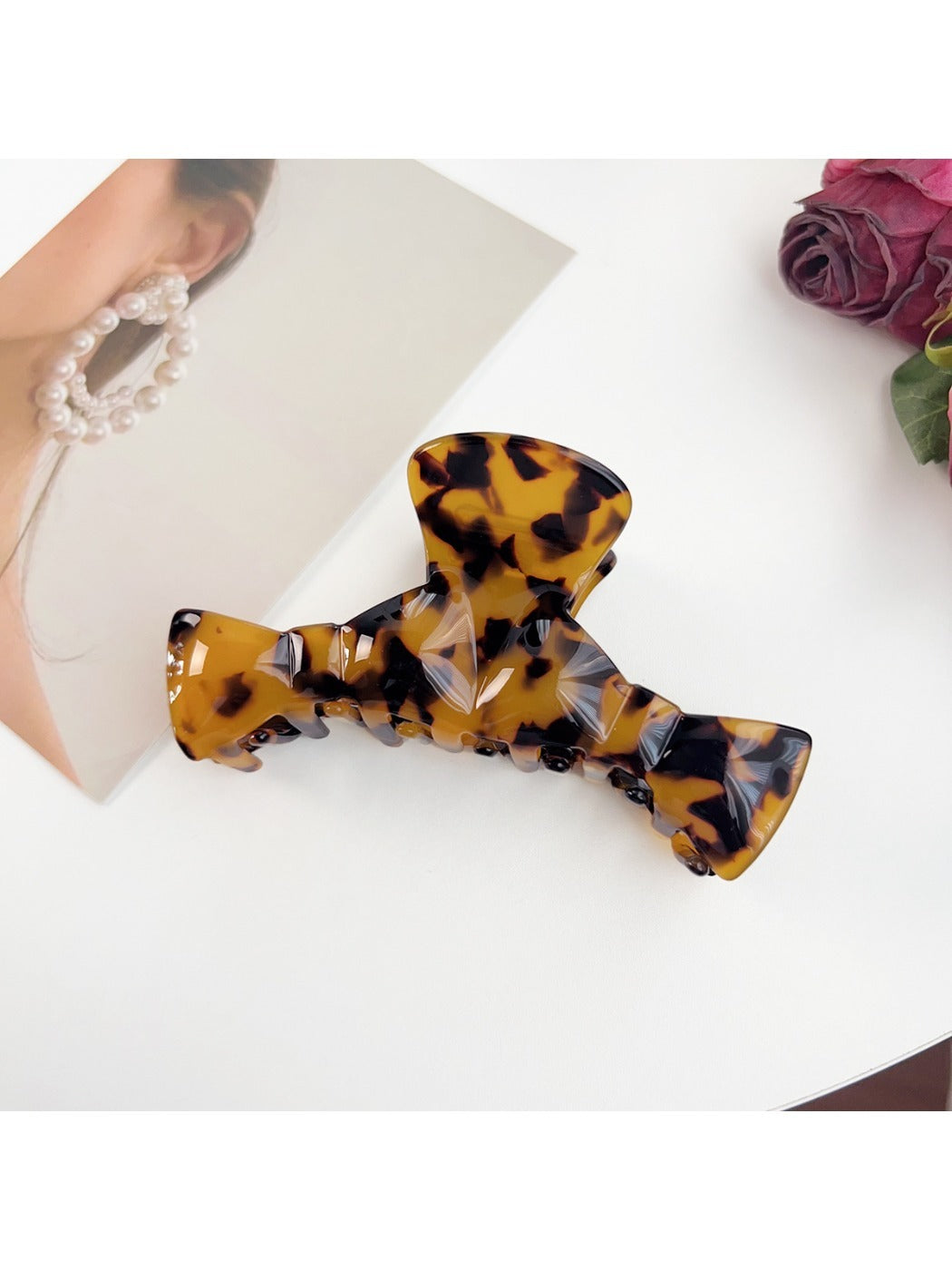 Beau claw clip placed on wooden surface with natural light
