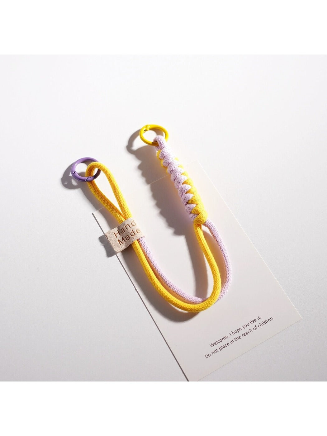 Colorful twisted rope keychain with metal ring isolated on white