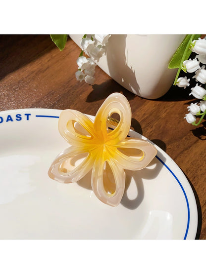 Beau openwork flower hair claw clip shown with packaging box