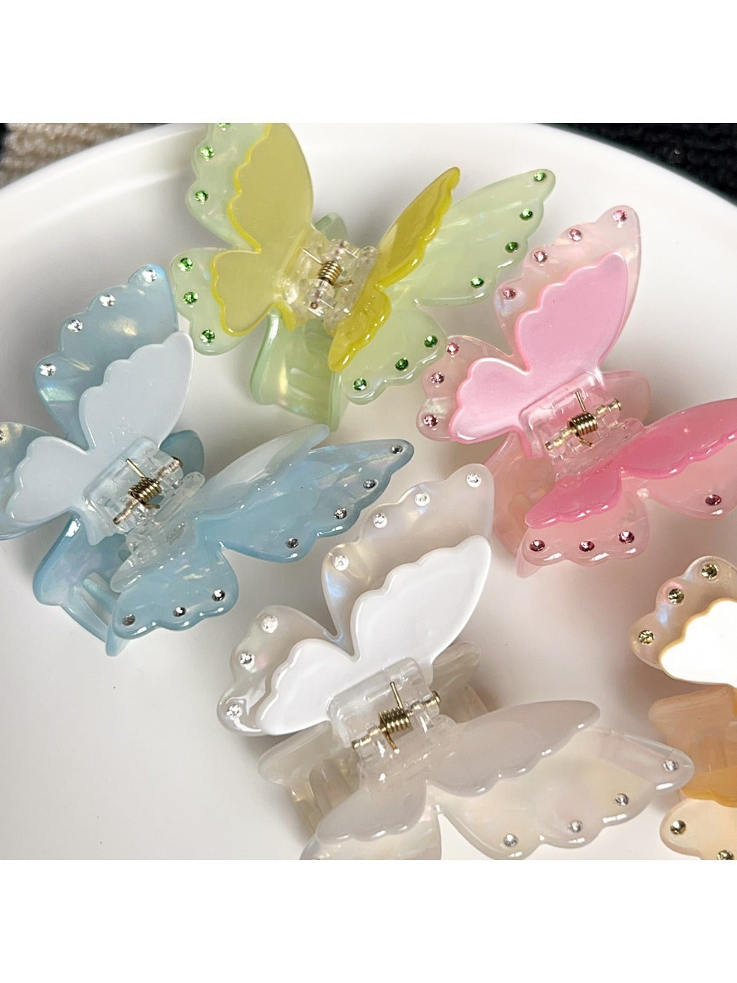 Beau butterfly claw clip open to display the claw teeth and spring mechanism