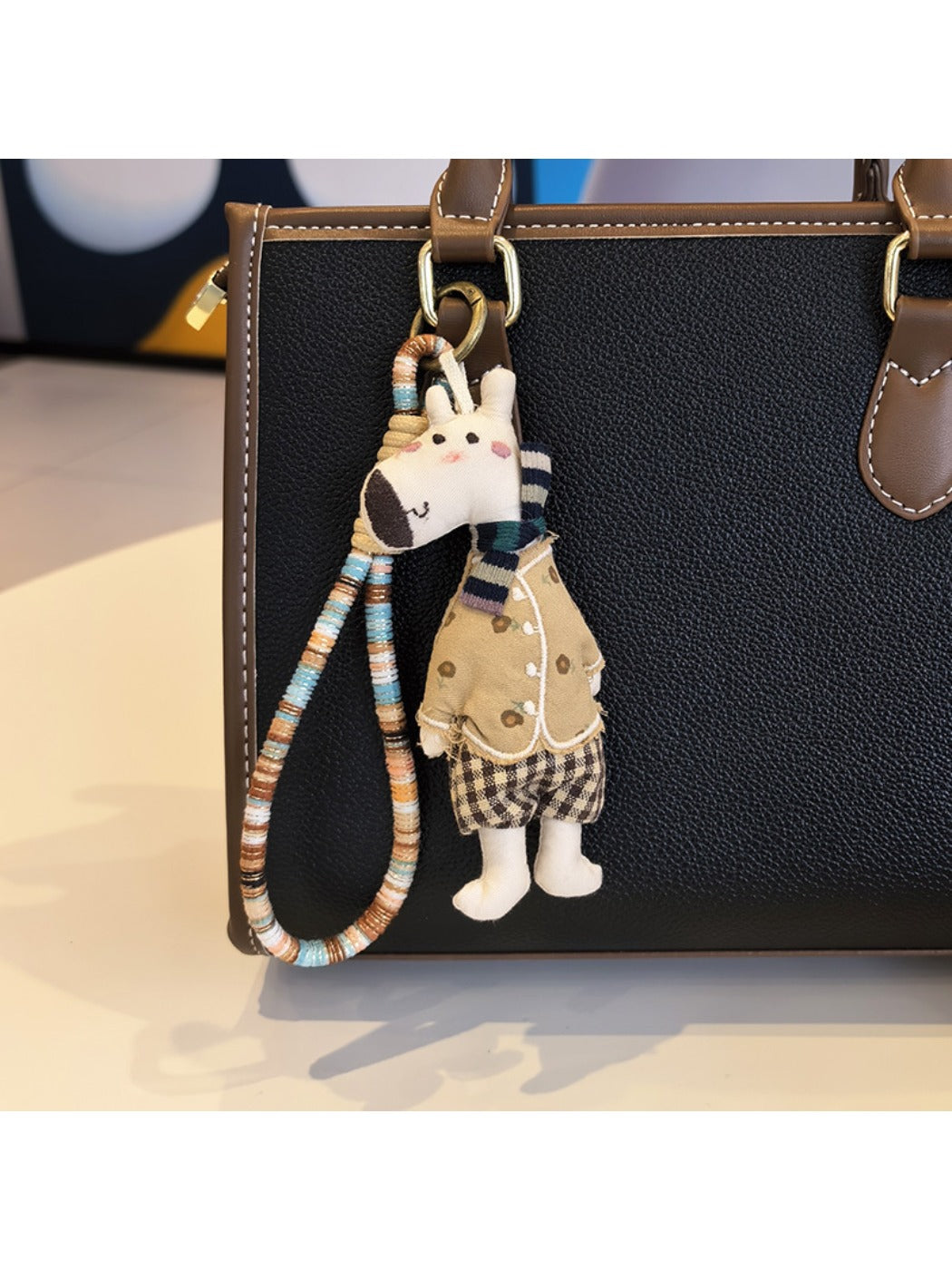 Top view of the giraffe charm keychain highlighting the keyring attachment