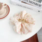 Beau Sweet Floral Print Hair Claw Clip resting on wooden surface