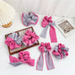 Magenta striped color block scrunchie on a white background
