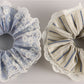 Gifty scrunchie styled on a wrist with black and white stripes