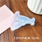 Beau blue ocean style claw clip next to seashells for thematic styling