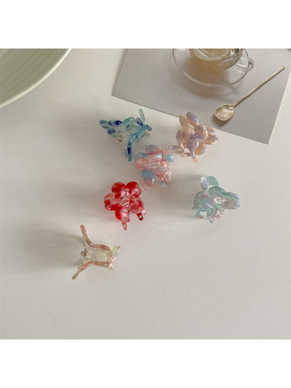 Side view of Beau sweet flower shaped small claw clip in pastel pink
