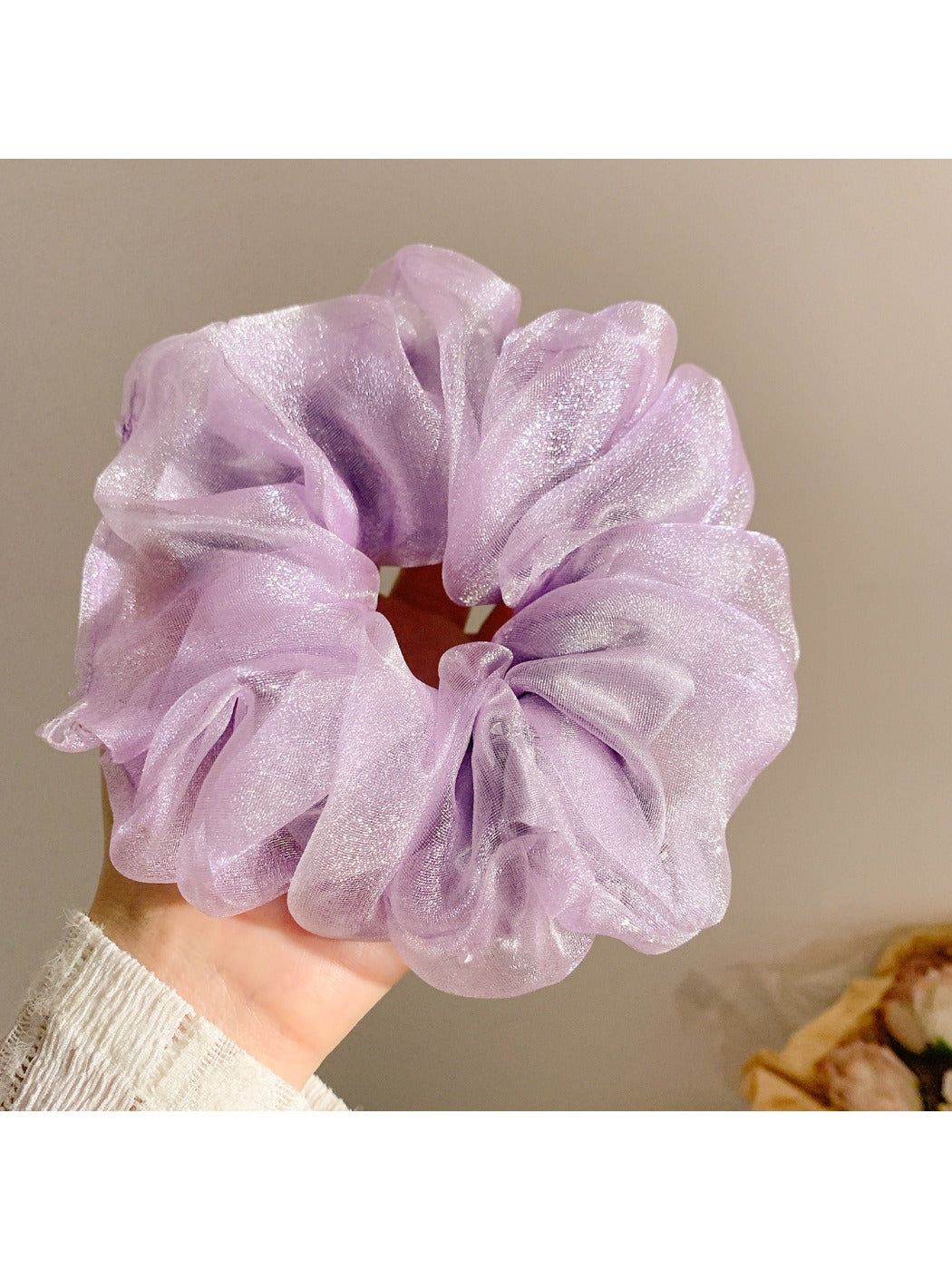 Solid color ruched scrunchie stretched to show elasticity and fabric detail