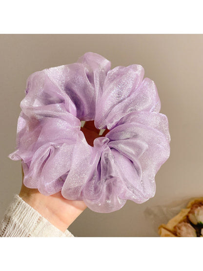 Solid color ruched scrunchie stretched to show elasticity and fabric detail