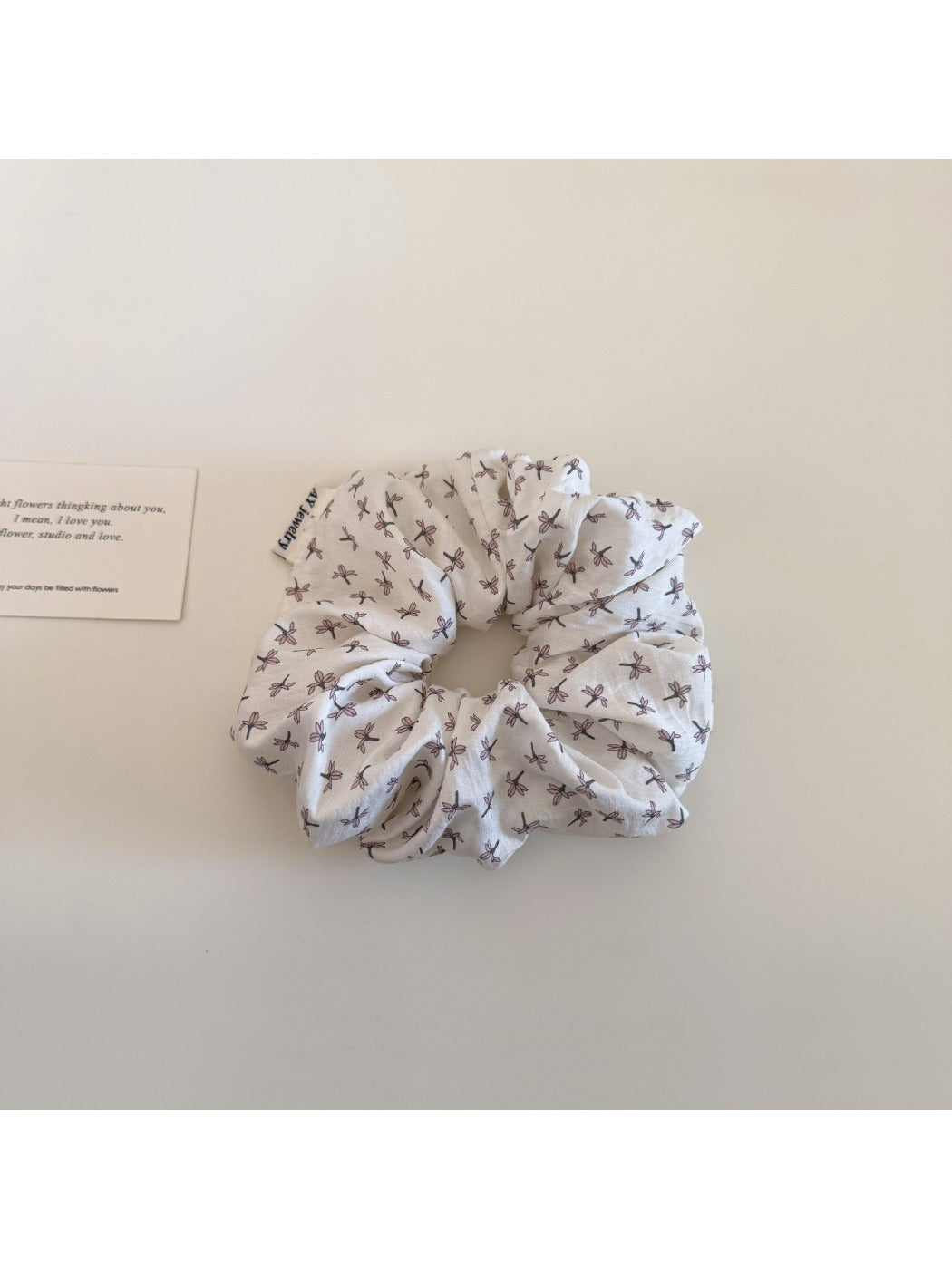 Flat lay of Gifty elegant ditsy floral scrunchie on white background showing full circular shape