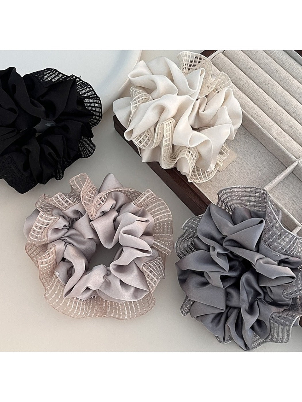Close-up of Gifty fashionable cut out ruched scrunchie in soft pink fabric