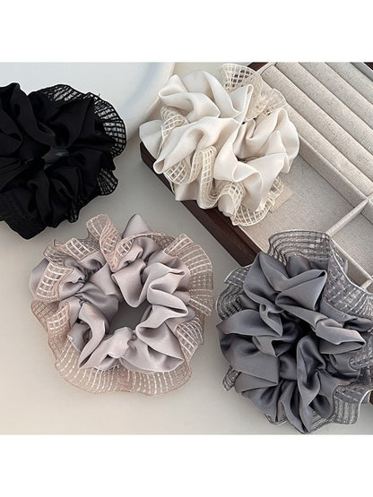 Close-up of Gifty fashionable cut out ruched scrunchie in soft pink fabric