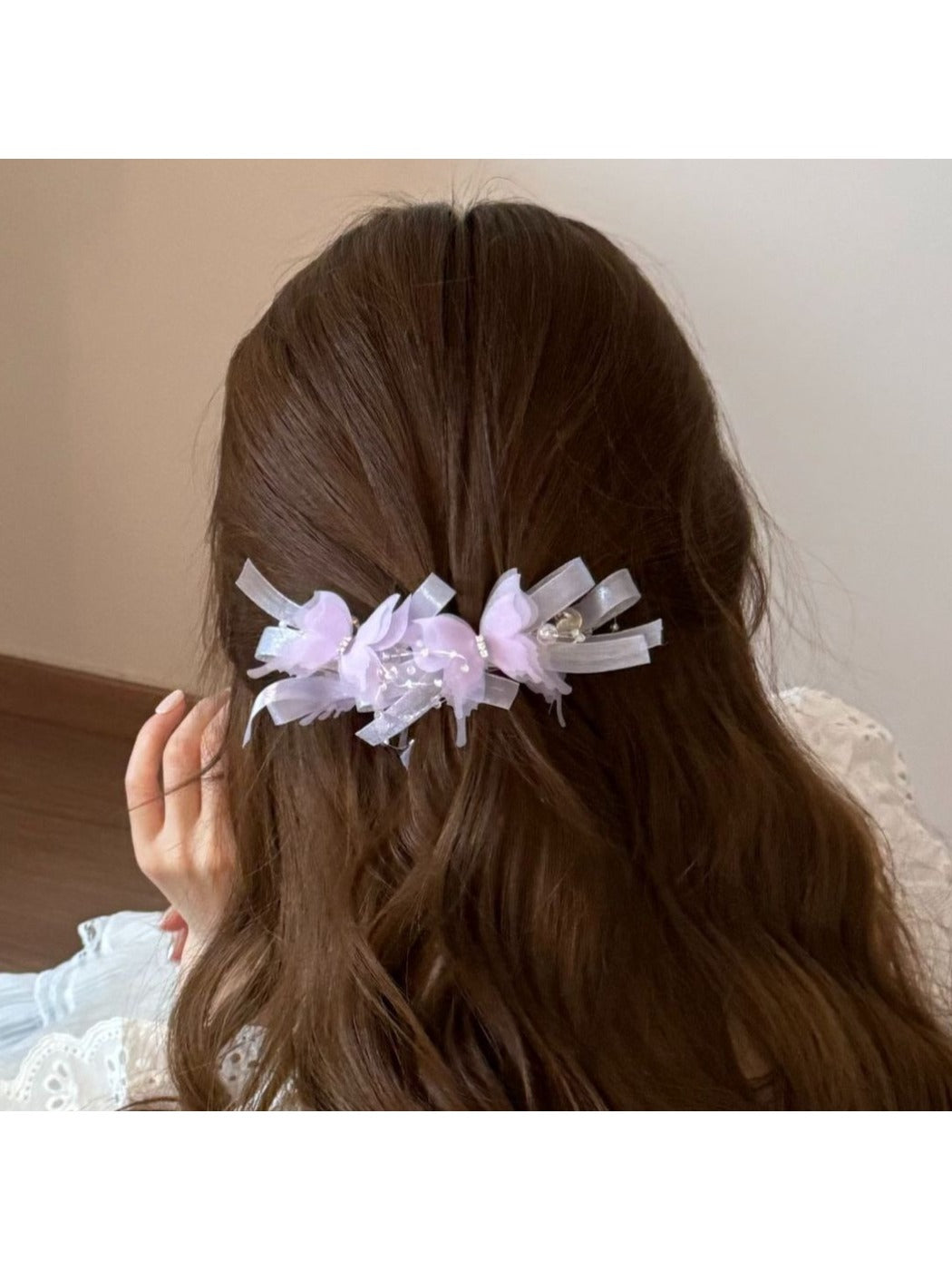 Side view of the Beau banana clip highlighting its curved shape and butterfly decorations