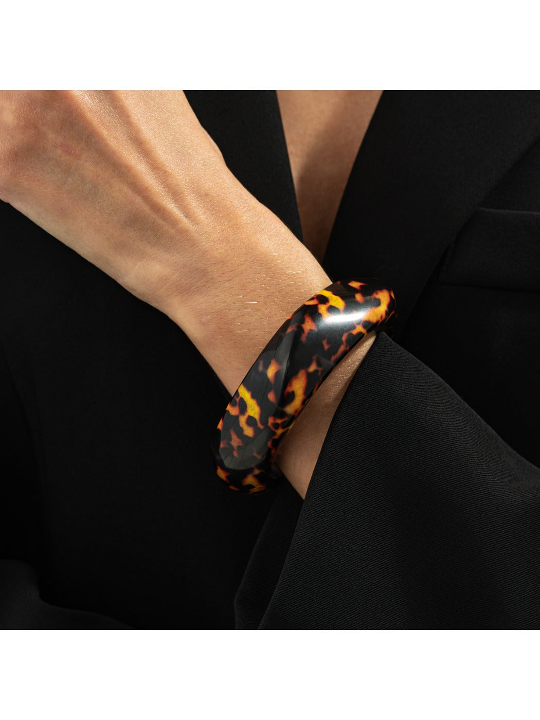 Lovra vintage asymmetrical bangle bracelet resting on a wooden surface