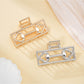 Beau Mysterious Retro Square Hair Clip in black with gold accents, front view