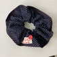 Blue scrunchie wrapped around a wrist as a fashion accessory