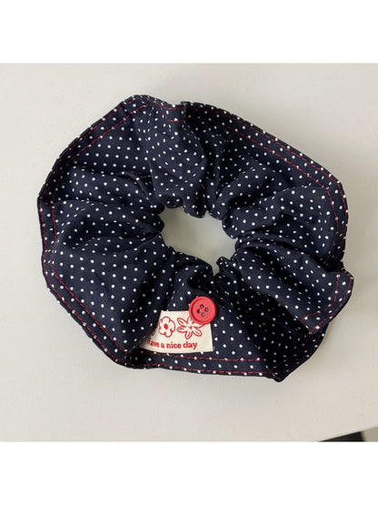 Blue scrunchie wrapped around a wrist as a fashion accessory