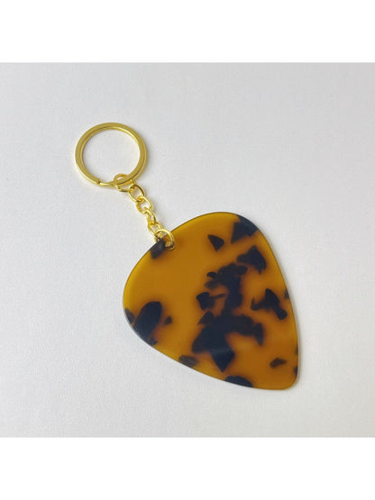 Silver teardrop charm keychain attached to a metal keyring on a dark fabric