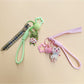 Fabric keychain shaped like a small animal with stitched details and a metal keyring
