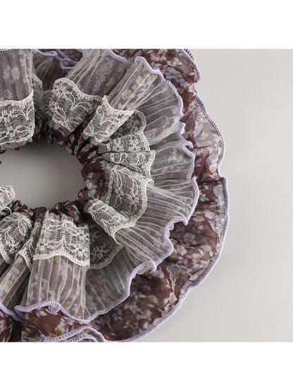 Side view of vintage purple floral scrunchie highlighting gathered fabric texture