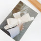 Beau minimalist bow claw clip in soft beige color on white background