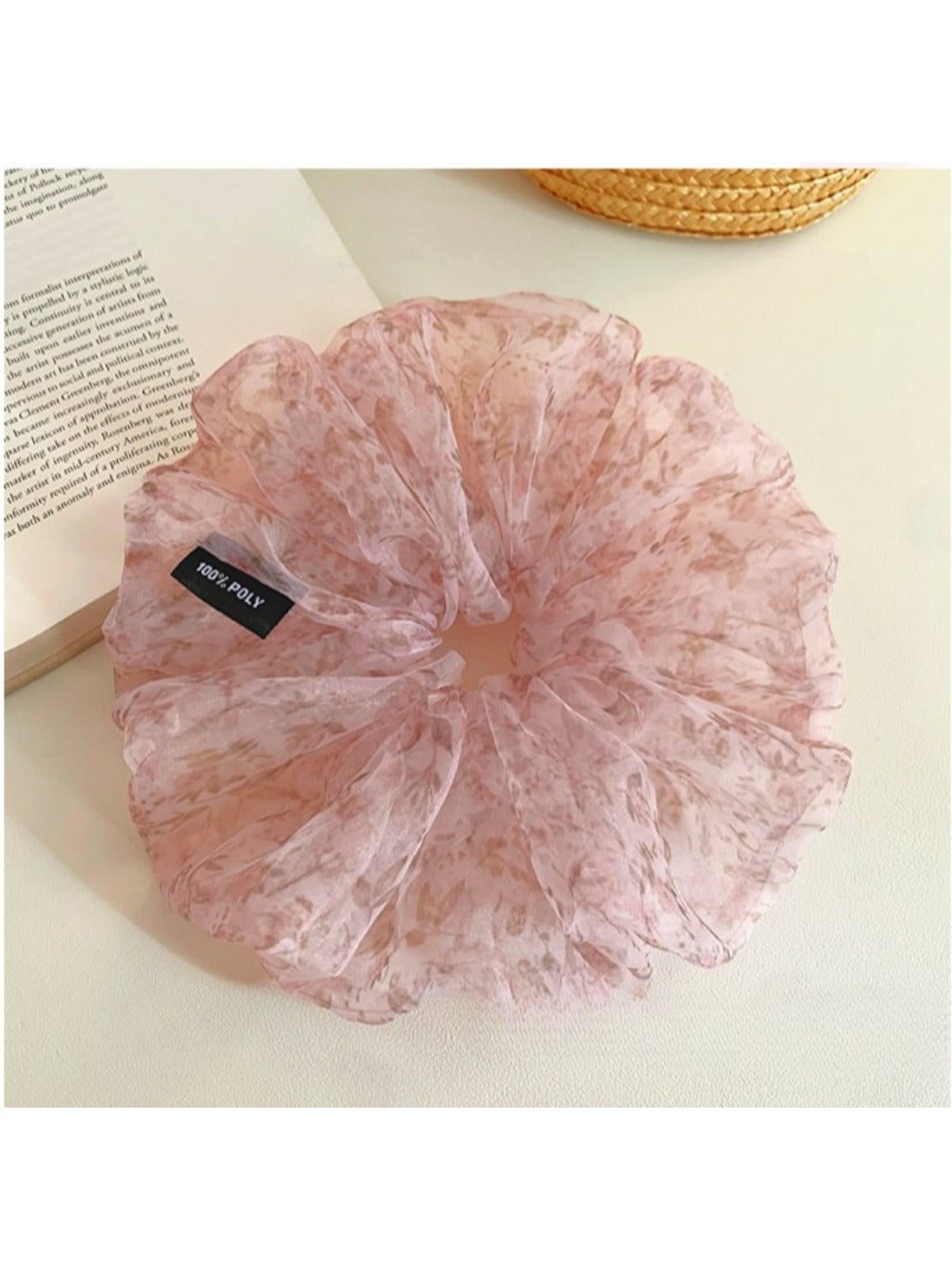 Side view of large pink tulle scrunchie highlighting fabric texture and flowers