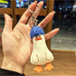 Side view of blue duck hair keychain highlighting its rounded shape