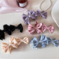 Beau satin bow banana clip in soft beige fabric on white background