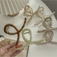 Beau large acetate claw clip holding thick hair in an updo style