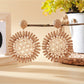 Model wearing elegant sunflower shaped drop earrings with gold finish