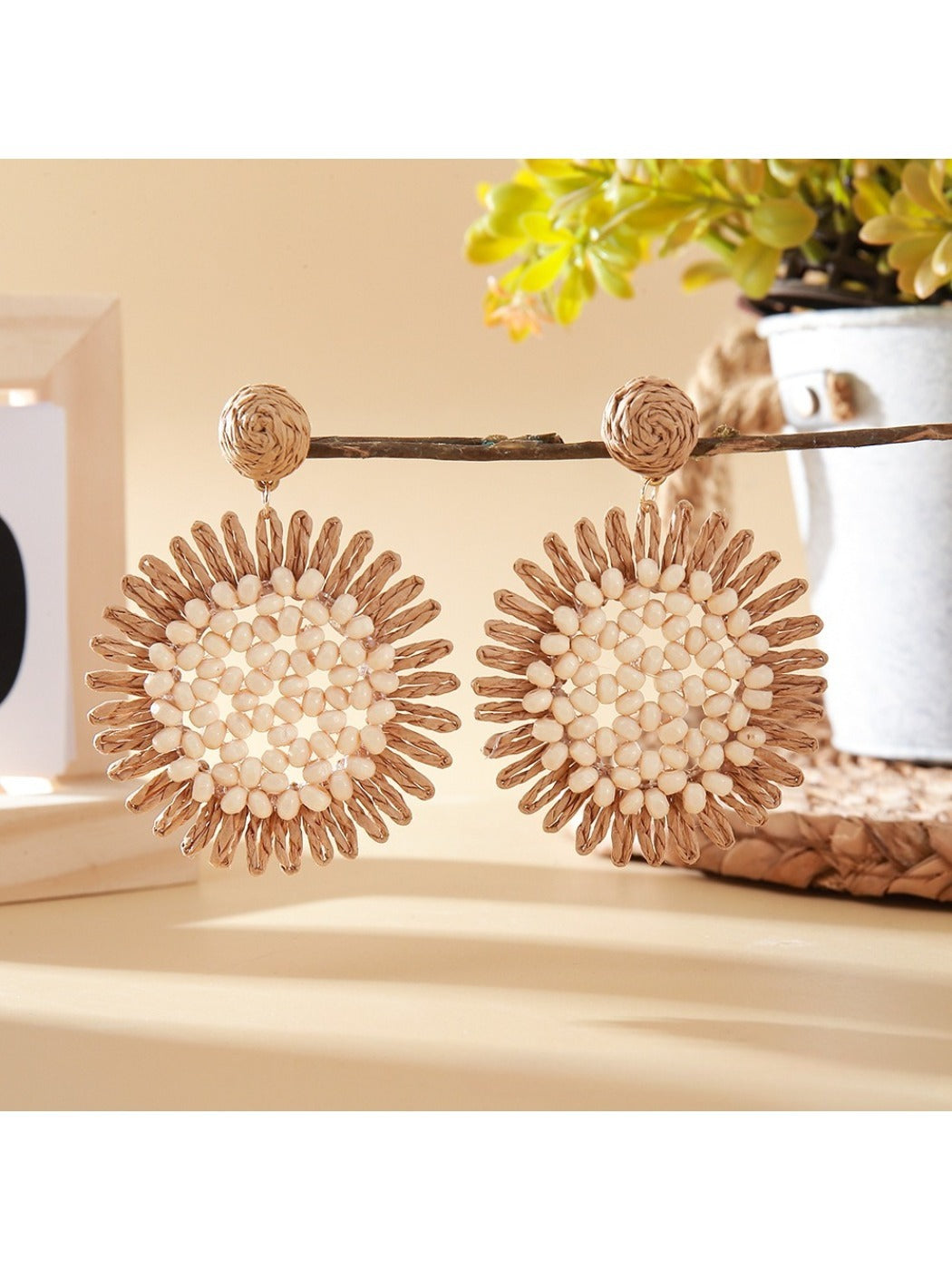 Model wearing elegant sunflower shaped drop earrings with gold finish