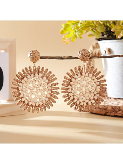 Model wearing elegant sunflower shaped drop earrings with gold finish
