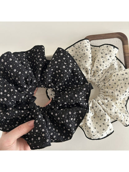 Gifty large floral scrunchie styled on a wrist as an accessory