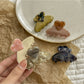 Beau heart shaped acetate claw clip held in hand to show size and shape