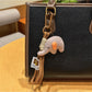 Elephant charm keychain displayed in a gift box with soft padding