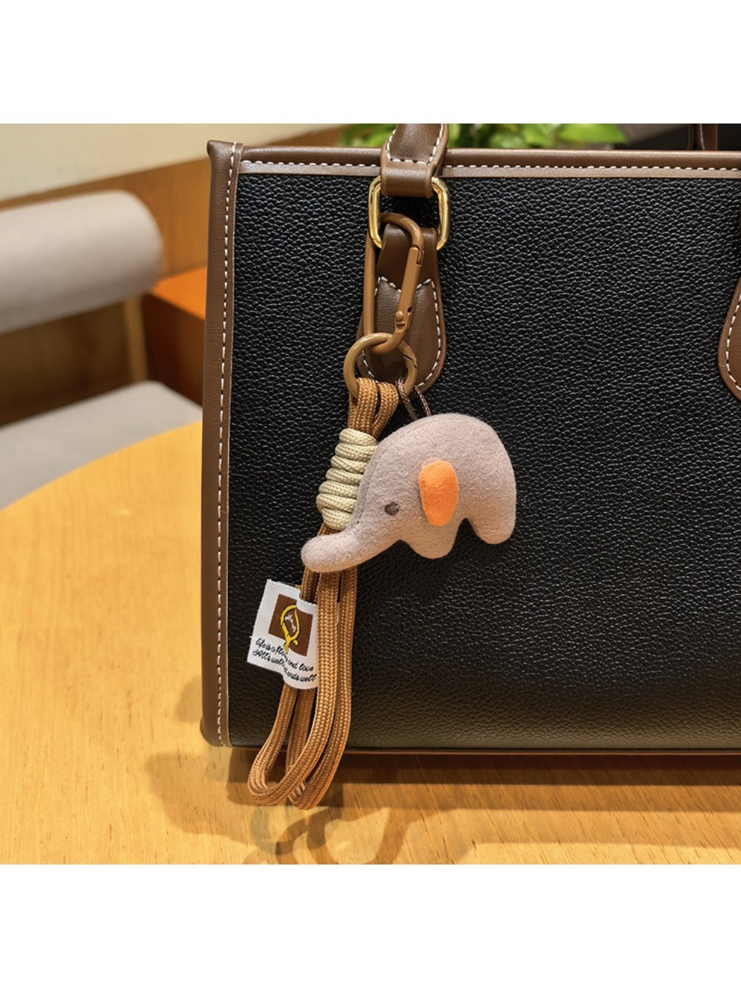Elephant charm keychain displayed in a gift box with soft padding