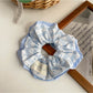 Hair clip close-up highlighting metal clasp and fabric cover