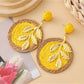 Earedge round leaf pendant earrings with a shiny gold surface close-up