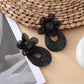 Top view of Sweet Raffia Flower Shaped Stud Earrings highlighting flower design
