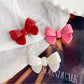 Close-up of Beau delicate bow hair clip showing textured fabric and gold detailing