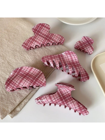 Beau pink plaid hair claw clip held in hand showing size and pattern