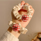 Flat lay of Gifty Sweet Plaid Cherry Hair Tie showing fabric texture and attached cherry charm