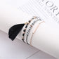 Lovra feather pendant small bead bracelet styled with casual outfit