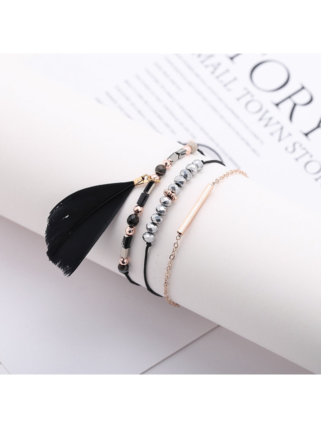 Lovra feather pendant small bead bracelet styled with casual outfit