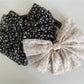 Beau chiffon bow hair clip worn in long brown hair styled half-up