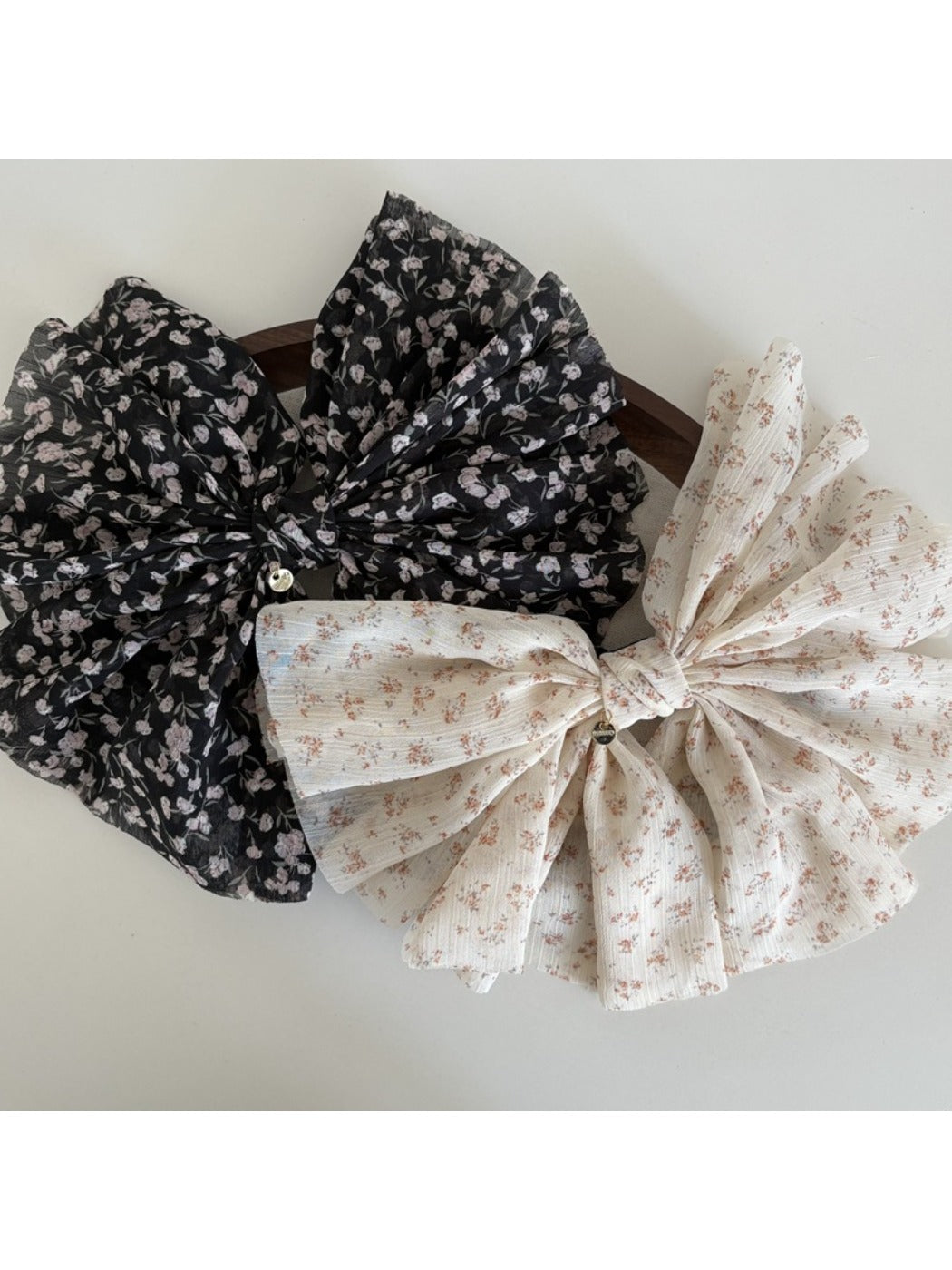 Beau chiffon bow hair clip worn in long brown hair styled half-up