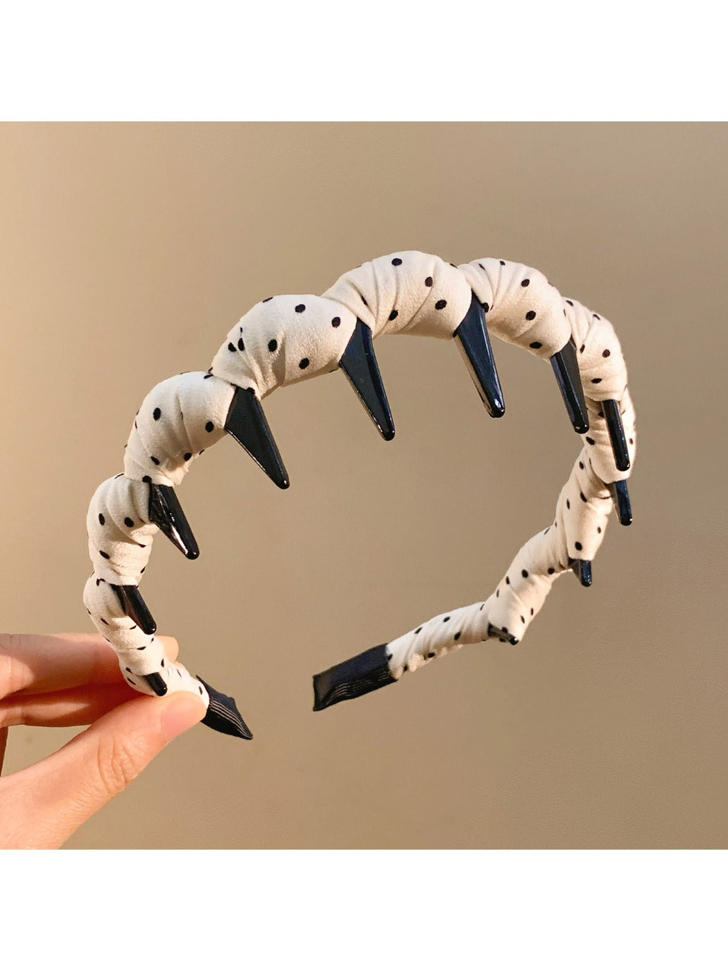 Gifty polka dot headband folded to show inner lining and texture