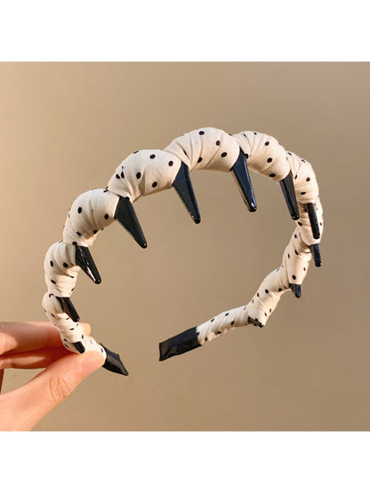 Gifty polka dot headband folded to show inner lining and texture