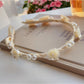 Soft white fabric headband with a chic twisted knot design