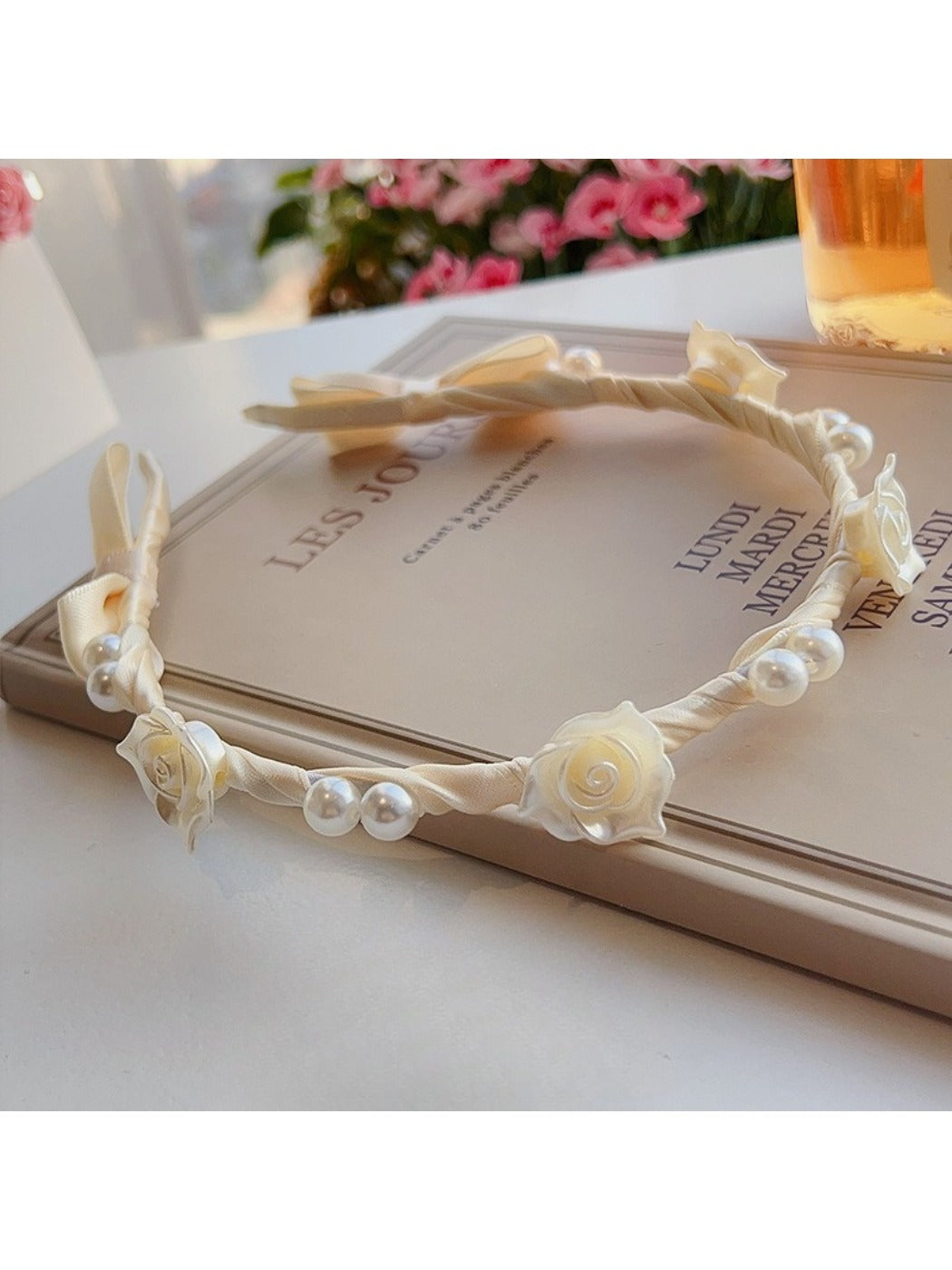 Soft white fabric headband with a chic twisted knot design